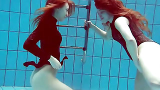 Underwater with two beauties in one piece swimsuits