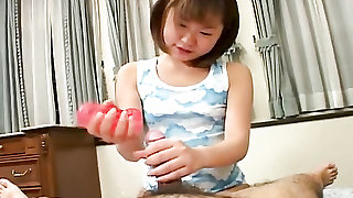 Cute Asian cocksucker uses a sex toy on him